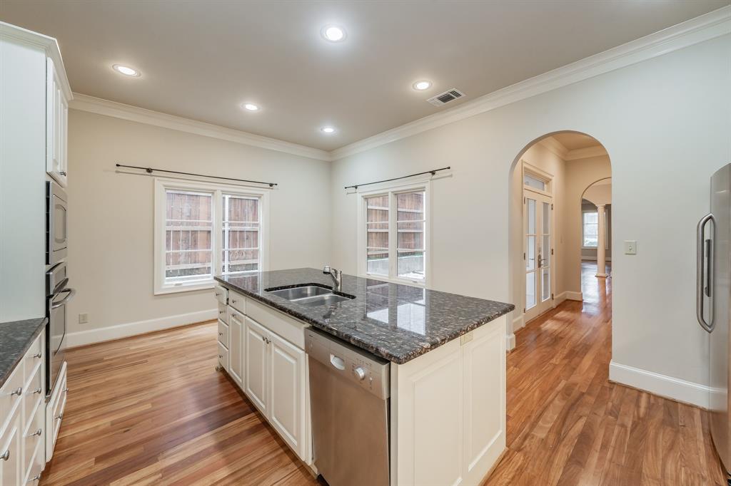 3635 Crestline Road Fort Worth, TX 76107 - Photo 12 of 40 a kitchen with stainless steel appliances granite countertop a stove and a wooden cabinets