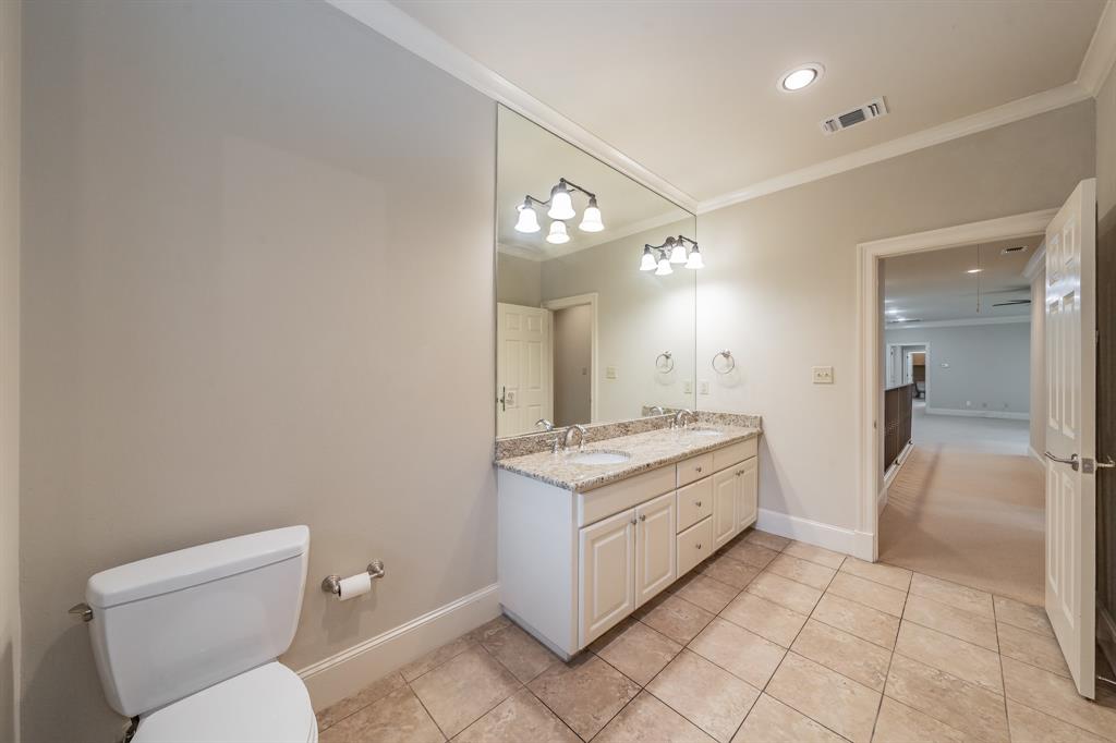 3635 Crestline Road Fort Worth, TX 76107 - Photo 20 of 40 a bathroom with a granite countertop sink a toilet and a mirror