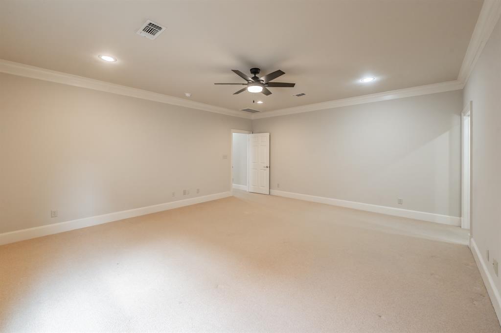 3635 Crestline Road Fort Worth, TX 76107 - Photo 21 of 40 an empty room with a chandelier fan and windows