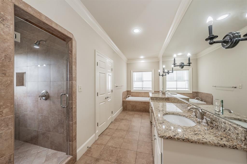 3635 Crestline Road Fort Worth, TX 76107 - Photo 34 of 40 a bathroom with a granite countertop sink mirror and shower
