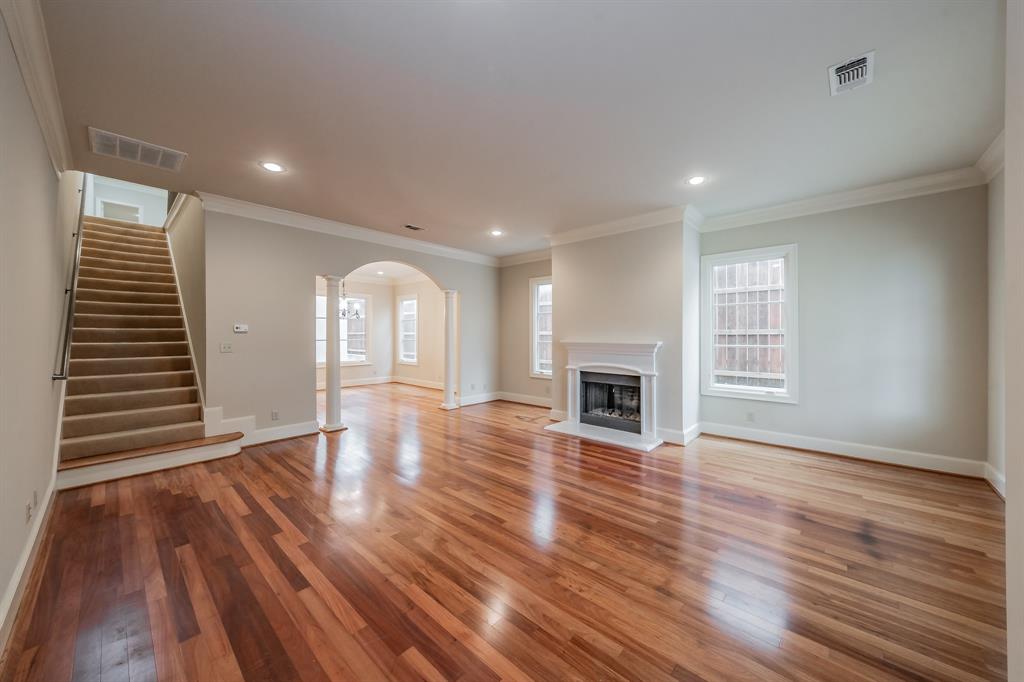 3635 Crestline Road Fort Worth, TX 76107 - Photo 6 of 40 a view of empty room with wooden floor and fireplace