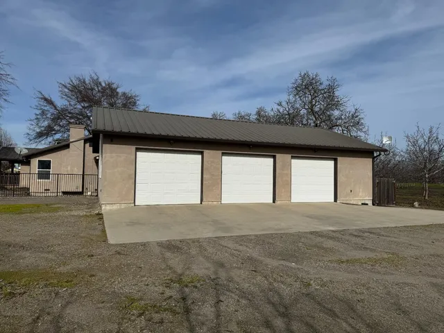 a view of empty room with wooden floor and fence