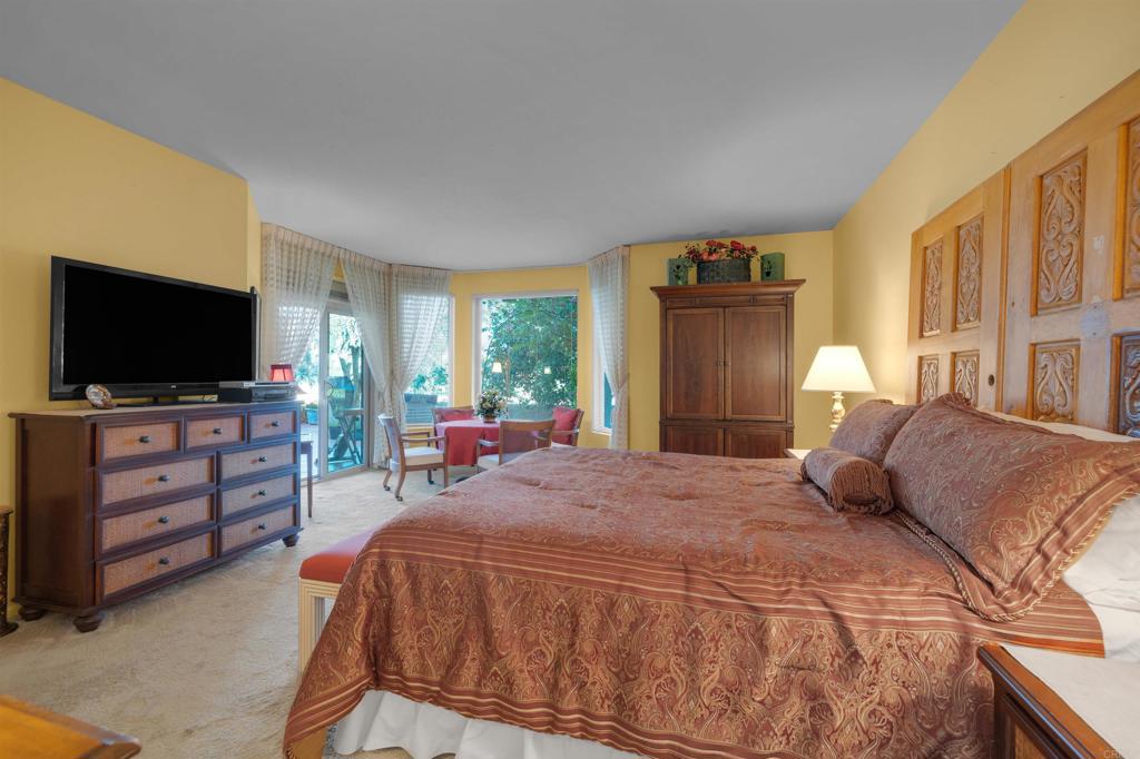 202 Pointing Rock Drive, Unit 6 Borrego Springs, CA 92004 - Photo 18 of 28 a bedroom with a bed and flat screen tv