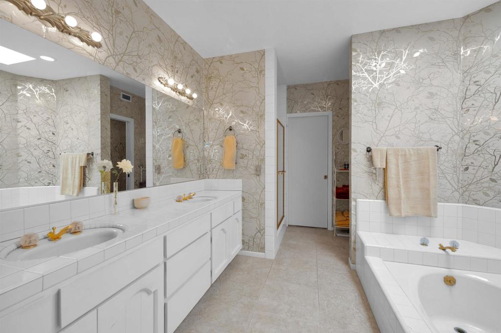 202 Pointing Rock Drive, Unit 6 Borrego Springs, CA 92004 - Photo 19 of 28 a spacious bathroom with double vanity sinks a large mirror and a shower
