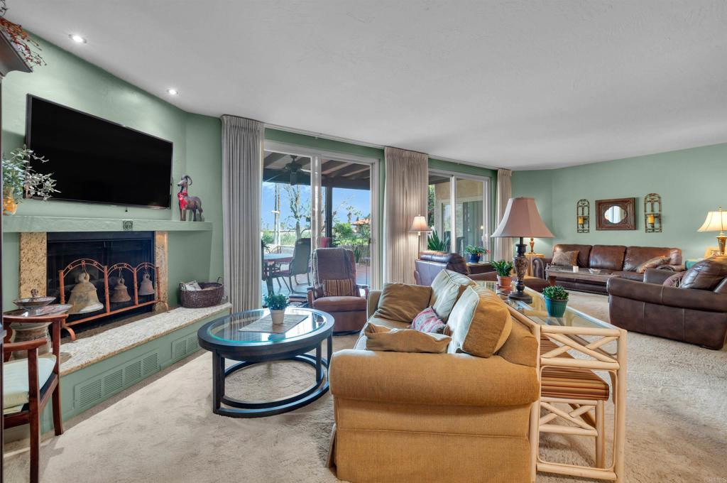 202 Pointing Rock Drive, Unit 6 Borrego Springs, CA 92004 - Photo 9 of 28 a living room with furniture a flat screen tv and a fireplace