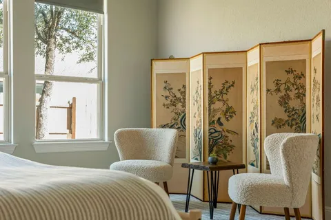 a bedroom with a bed and a chair