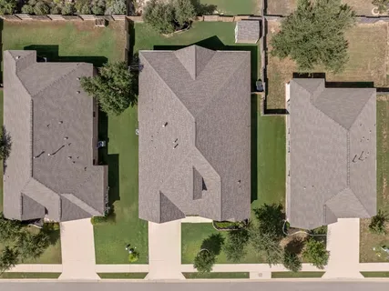 an aerial view of a house with a yard