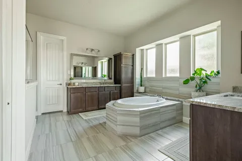 a bath tub sitting next to a bathroom sink