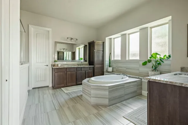 a bath tub sitting next to a bathroom sink