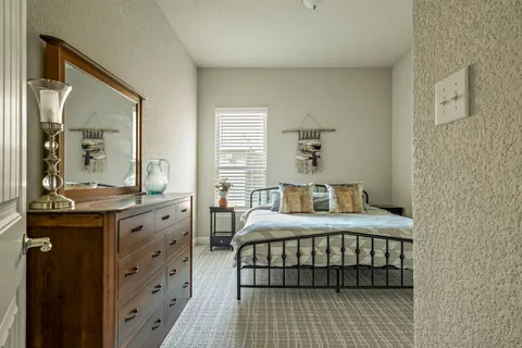 a bedroom with a bed and a window