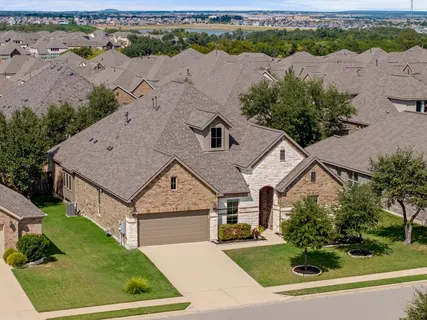 an aerial view of a house with a yard