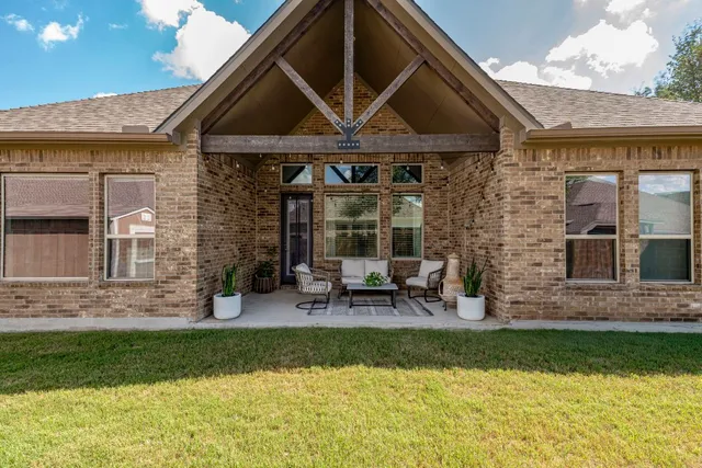 a view of a house with pool and sitting area
