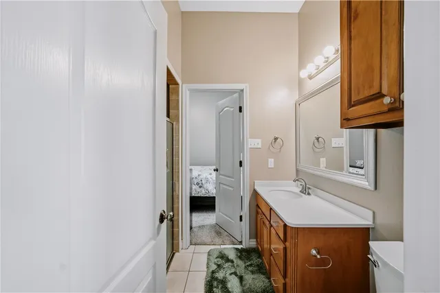a spacious bathroom with a sink a mirror and a shower
