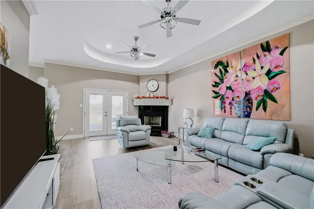 a living room with furniture a fireplace and a flat screen tv