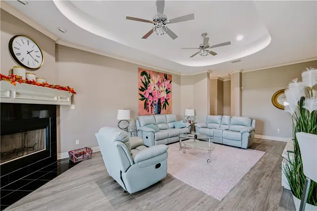 a living room with furniture a clock and a fireplace