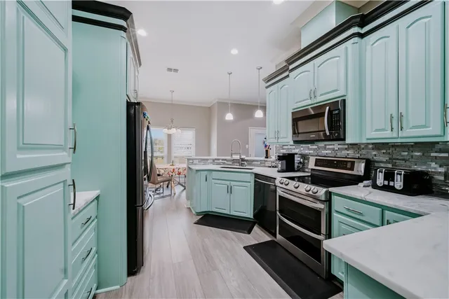 a kitchen with a sink stainless steel appliances and cabinets
