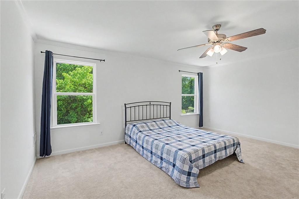 2310 Portrush Way Southeast Atlanta, GA 30339 - Photo 27 of 38 a bedroom with a large bed and a window