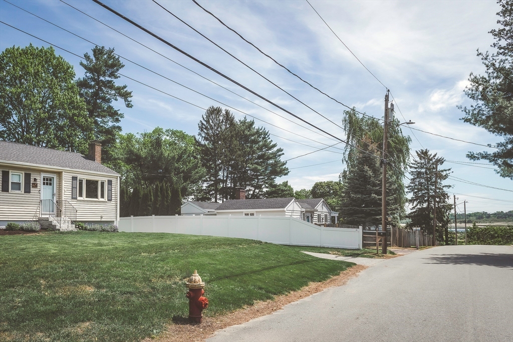 24 Island Park Road Ipswich, MA 01938 - Photo 18 of 25 a front view of a house with a yard and tree s