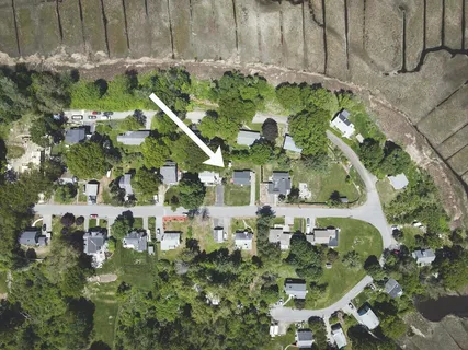 an aerial view of residential houses with outdoor space
