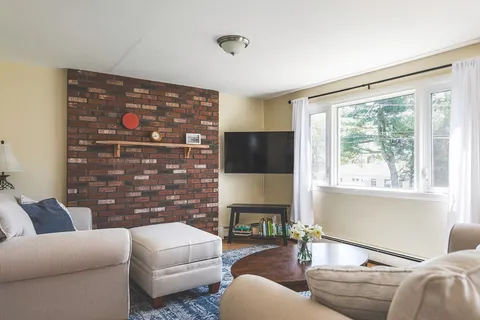 a bathroom with a sink a toilet and a window