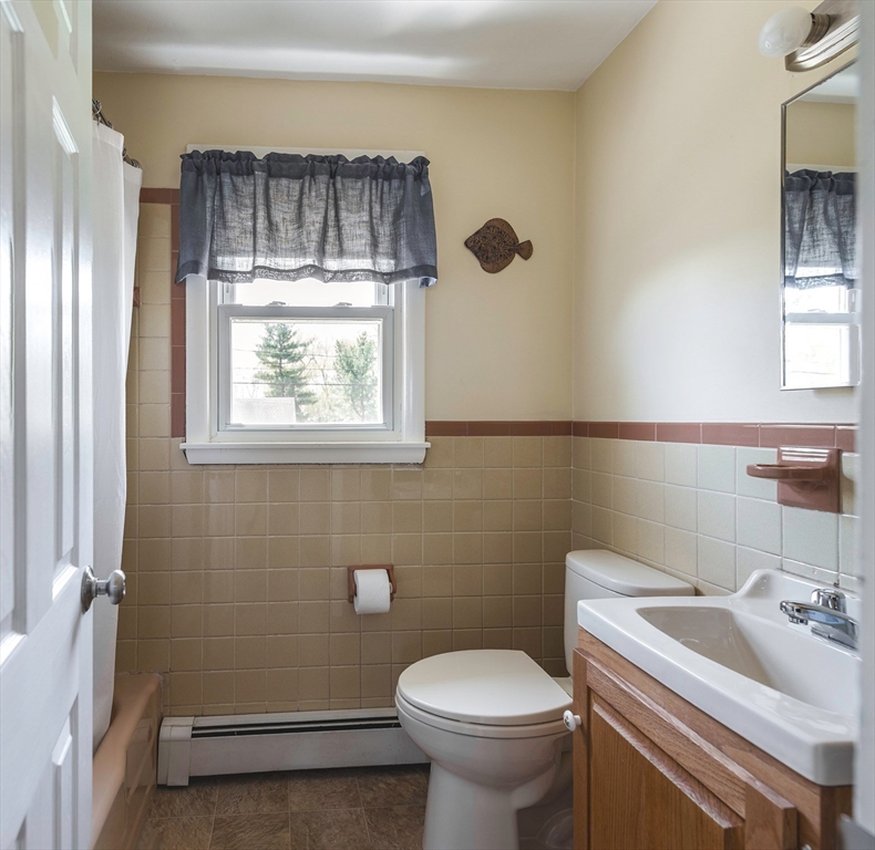 24 Island Park Road Ipswich, MA 01938 - Photo 9 of 25 a bathroom with a sink a toilet and a window