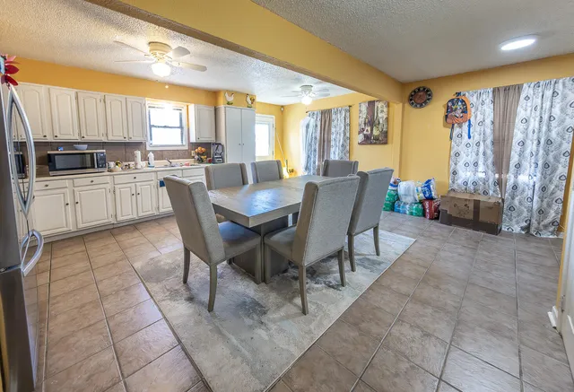 a kitchen with stainless steel appliances kitchen island granite countertop a sink and cabinets