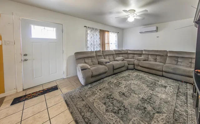 a living room with furniture and a rug