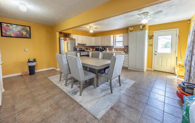 a dining room with a table and chairs