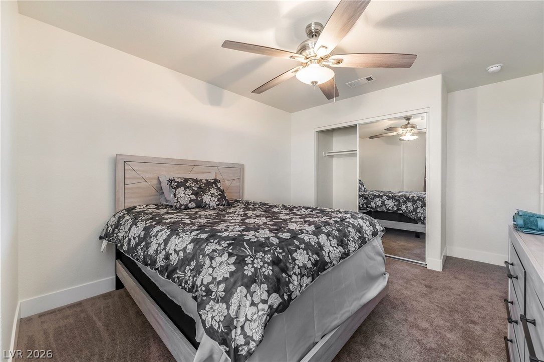 104 Appian Way Henderson, NV 89002 - Photo 19 of 24 Well-lit bedroom features ample closet space and a stylish ceiling fan.