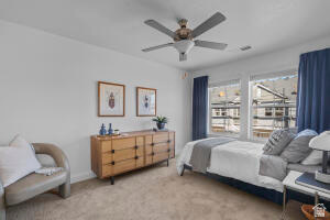 907 West Bright Ridge Ln Street, Unit 1430 St. George, UT 84790 - Photo 13 of 19 Bright bedroom featuring dual windows, ceiling fan with integrated lighting, and neutral carpeting