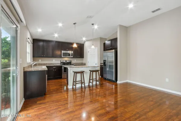 a kitchen with a refrigerator and a microwave