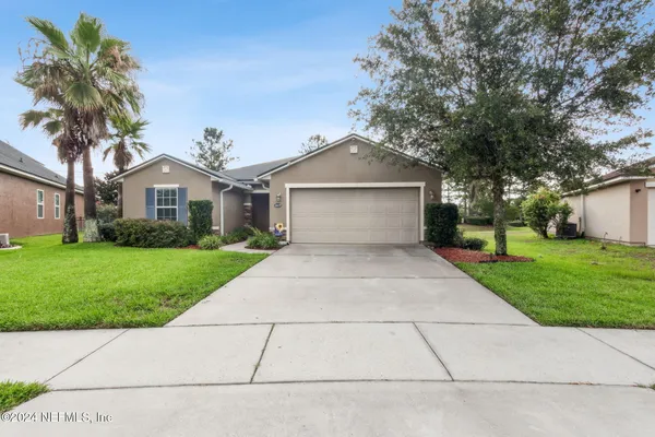 a front view of house with yard and green space