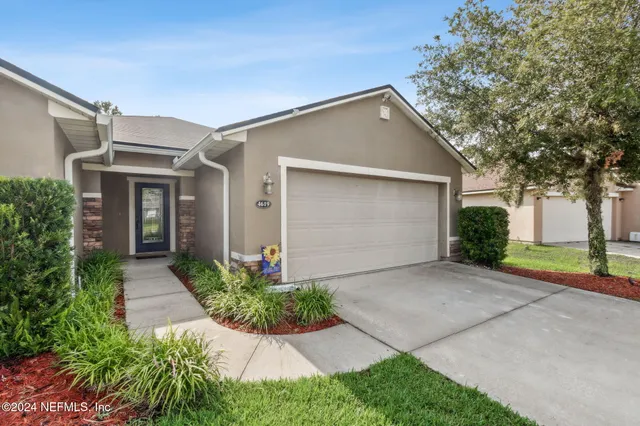 a front view of house with yard and green space