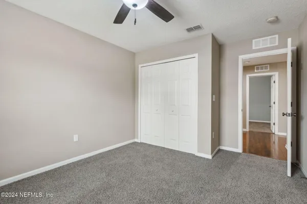an empty room with a empty space and a ceiling fan