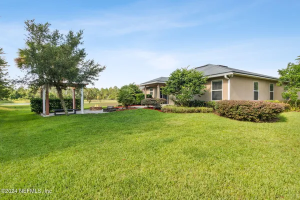 a front view of house with yard and green space