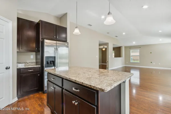 a kitchen with a refrigerator and countertop