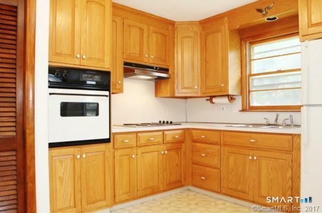 101 Waller Road Bridgeport, CT 06606 - Photo 4 of 10 a kitchen with granite countertop cabinets stainless steel appliances and a sink