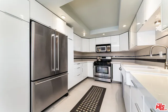 a kitchen with a refrigerator stove and sink