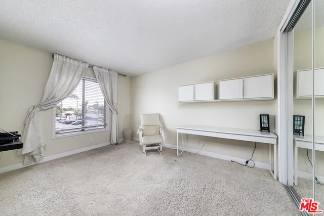 a view of workspace with window and cabinet