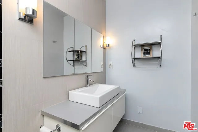 a bathroom with a sink toilet and mirror