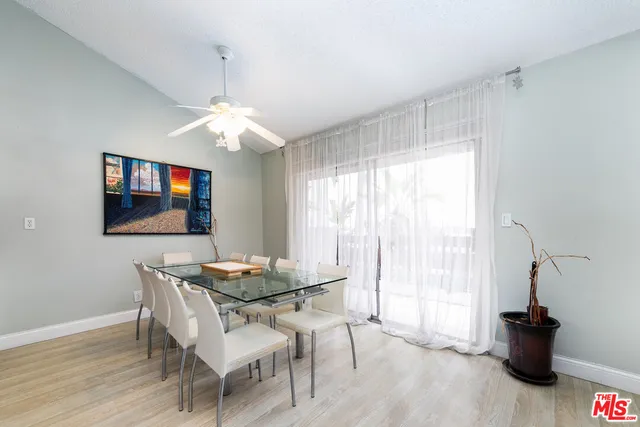 a dining room with furniture a chandelier and wooden floor