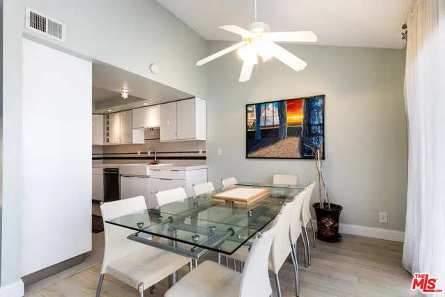 a kitchen with a table chairs and chandelier