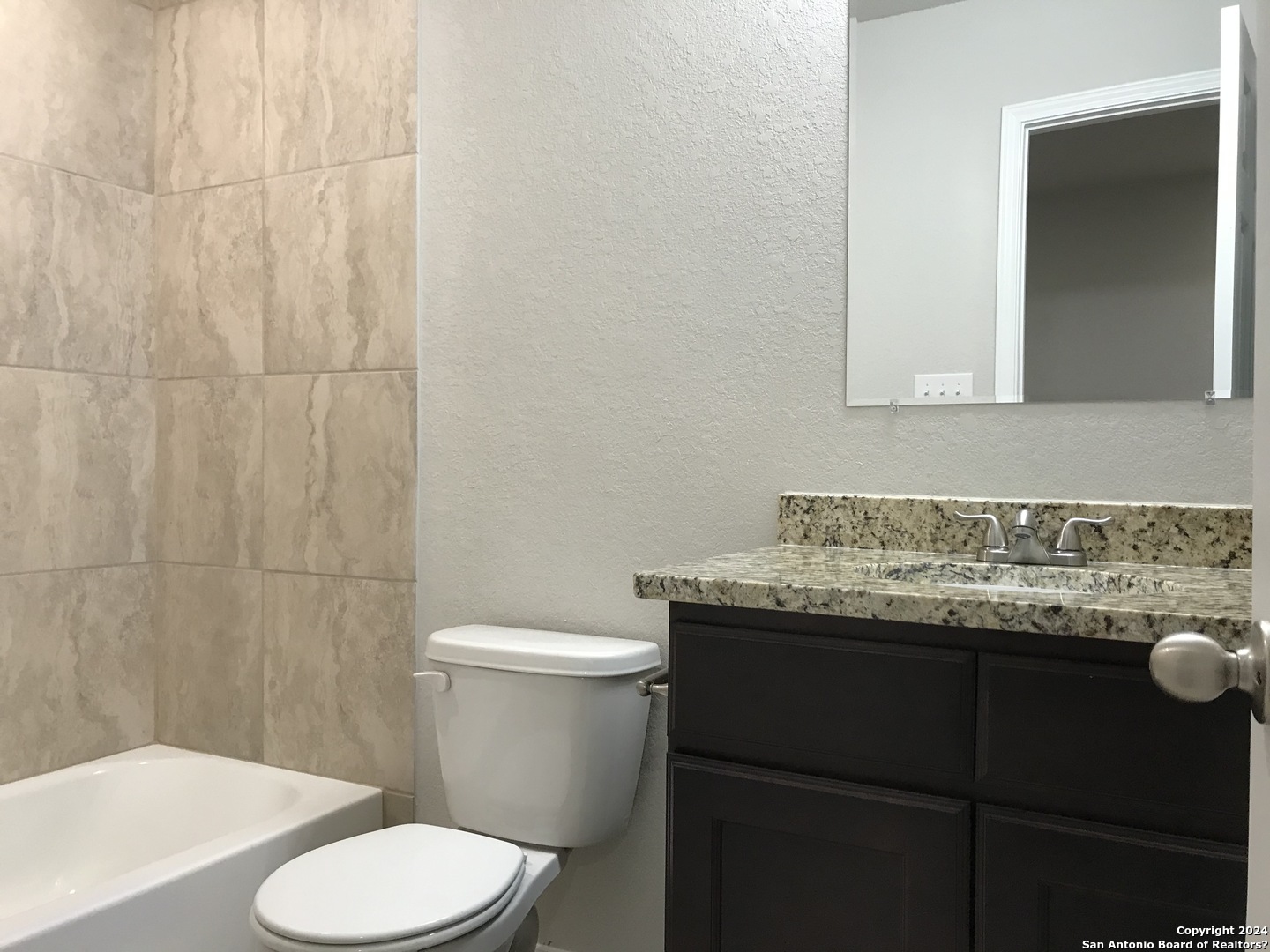 16905 Spirit Brook, Unit 2 Selma, TX 78154 - Photo 14 of 15 a bathroom with a granite countertop sink and a toilet