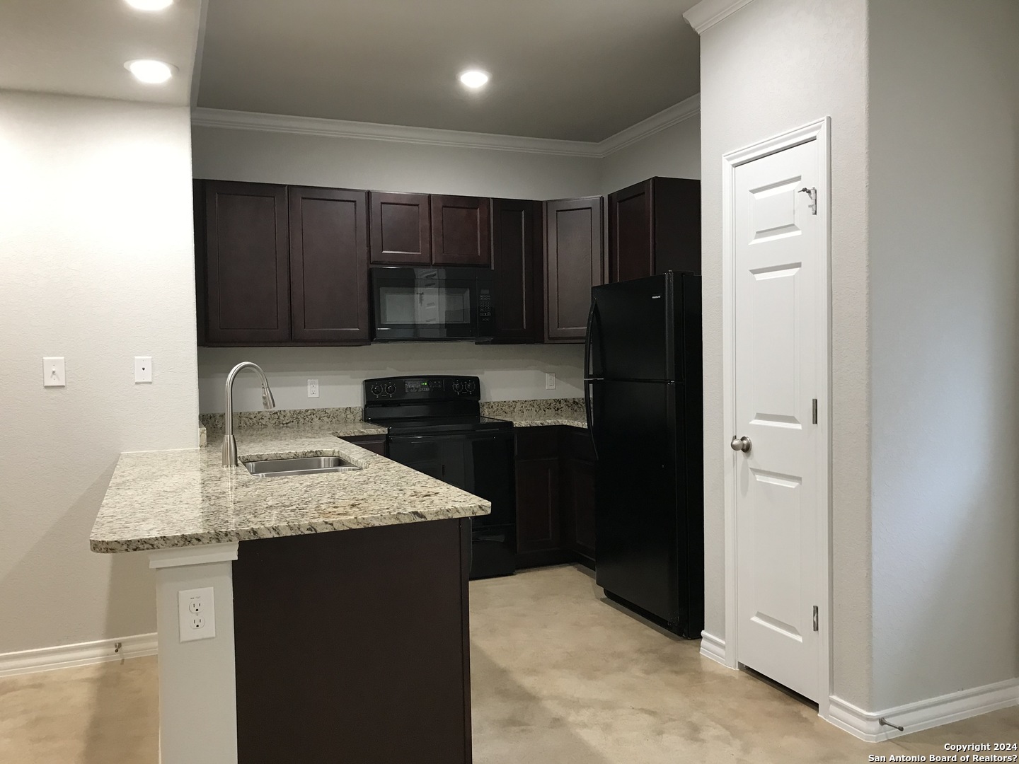 16905 Spirit Brook, Unit 2 Selma, TX 78154 - Photo 3 of 15 a kitchen with a refrigerator and a sink