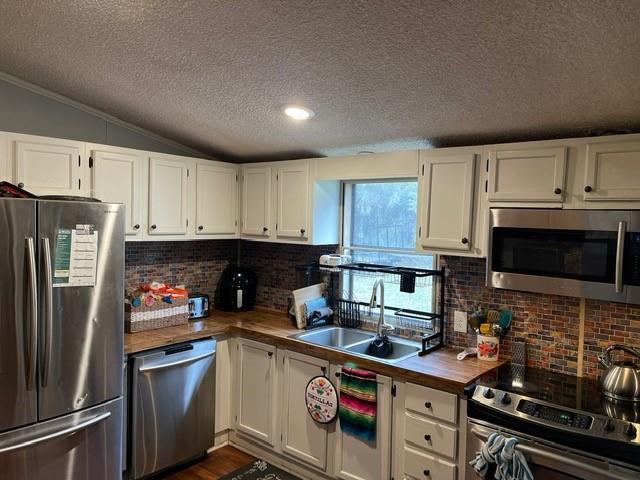 1765 Hall Spencer Road Edgemoor, SC 29712 - Photo 6 of 24 a kitchen with stainless steel appliances a stove a sink a refrigerator a microwave and cabinets