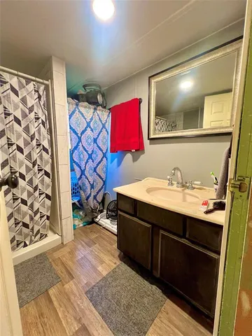 a bathroom with a sink mirror and vanity