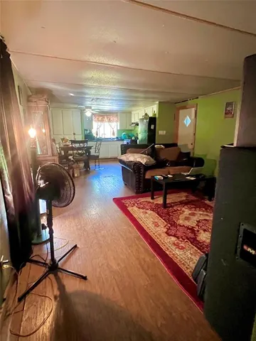 a living room with furniture a rug and gym equipment