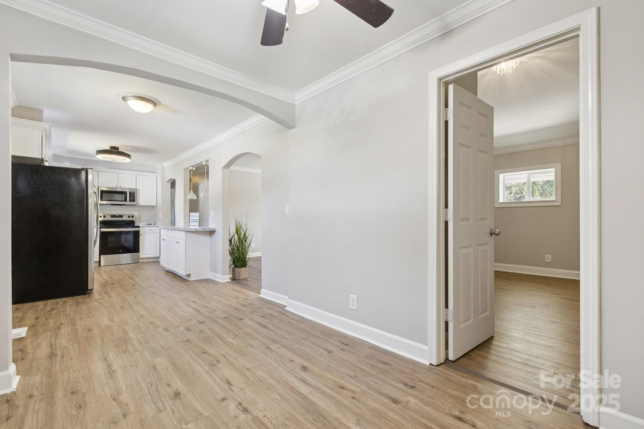 1024 Old Mountain View Road Mount Holly, NC 28120 - Photo 17 of 41 a view of a kitchen with refrigerator and wooden floor