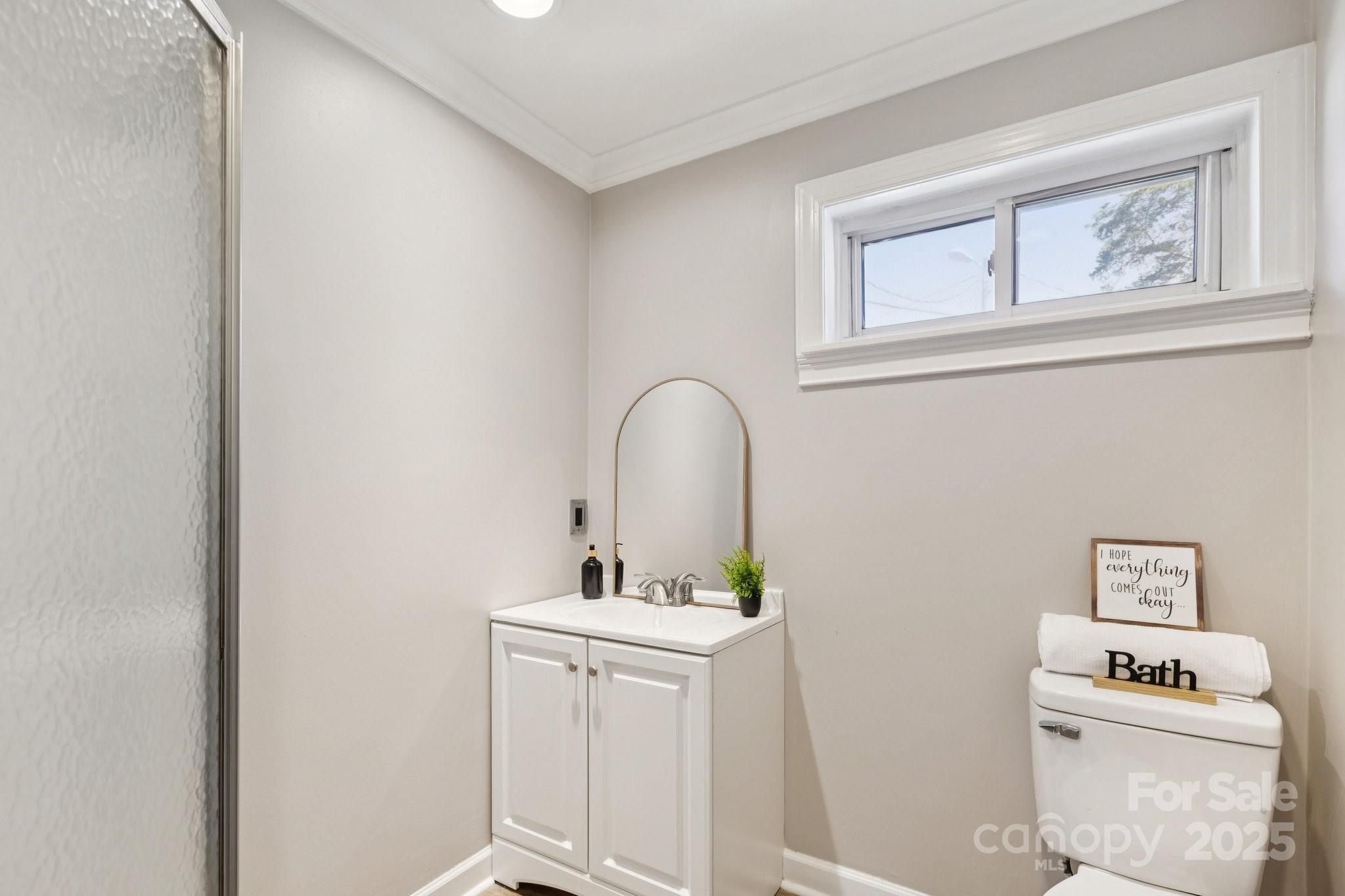 1024 Old Mountain View Road Mount Holly, NC 28120 - Photo 24 of 41 a bathroom with a sink a toilet and a window