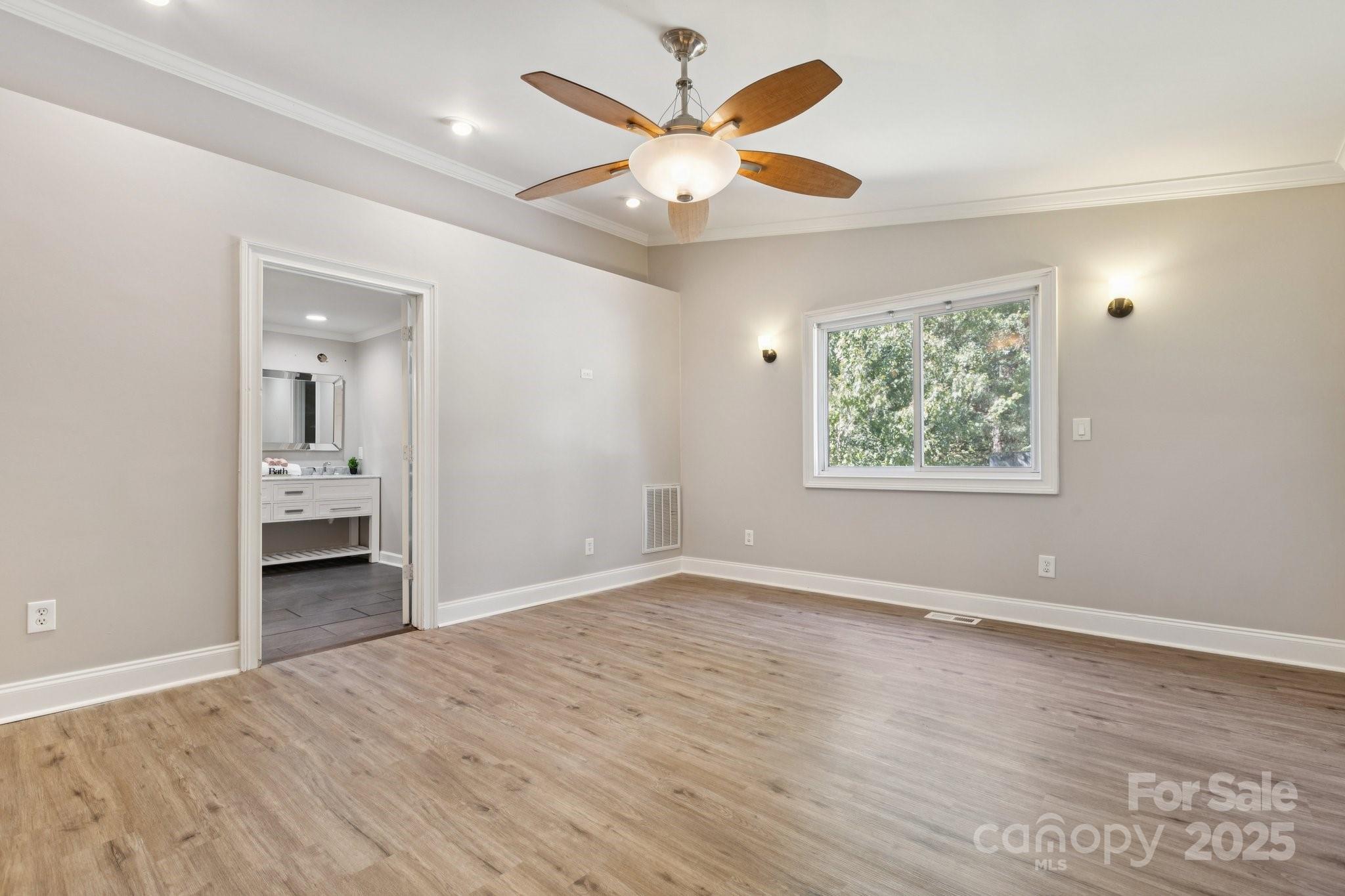 1024 Old Mountain View Road Mount Holly, NC 28120 - Photo 34 of 41 an empty room with wooden floor and ceiling fan